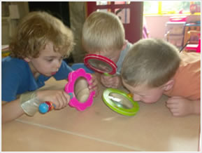 Children using maginifying glasses to teach co-ordination